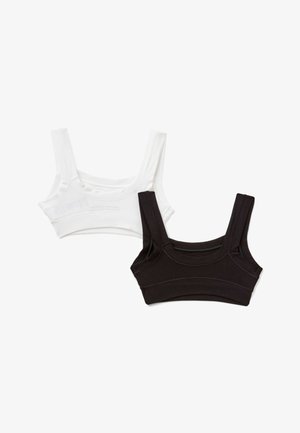 Due bralette corti in bianco e nero, con spalline spesse, design senza cuciture e tessuto morbido ed elastico.