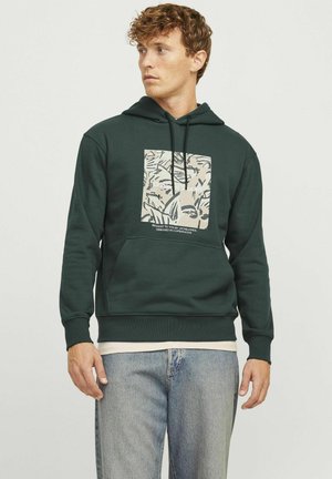 Dark green hoodie with a front pocket and drawstring hood. Features a beige graphic print of leaves on the chest. Soft material, casual fit.