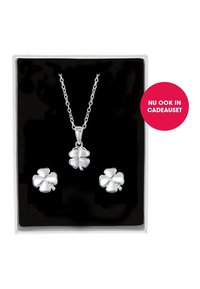 Silver jewelry set featuring a necklace with a four-leaf clover pendant and matching earrings, presented in a black box.