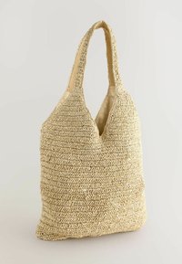 Vävd tote-väska i naturlig beige, med en mjuk texturerad yta, dubbla axelremmar och en rymlig, ostrukturerad design.