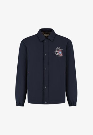 Jūras zila pogām aprīkota jaka ar apkakli, elastīgām piedurknēm un izšūtu tekstu "Iztīri savu prātu" ar ziedu dizainu kreisajā krūtīs.