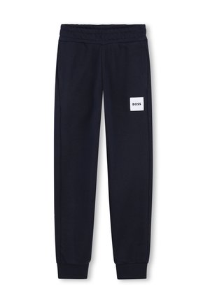 Pantalon de survêtement bleu marine avec taille et poignets élastiques, doté d'un patch logo rectangulaire blanc portant l'inscription "BOSS" sur la cuisse droite.