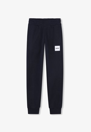 Pantalon de survêtement bleu marine avec taille et poignets élastiques, doté d'un patch logo rectangulaire blanc portant l'inscription "BOSS" sur la cuisse droite.