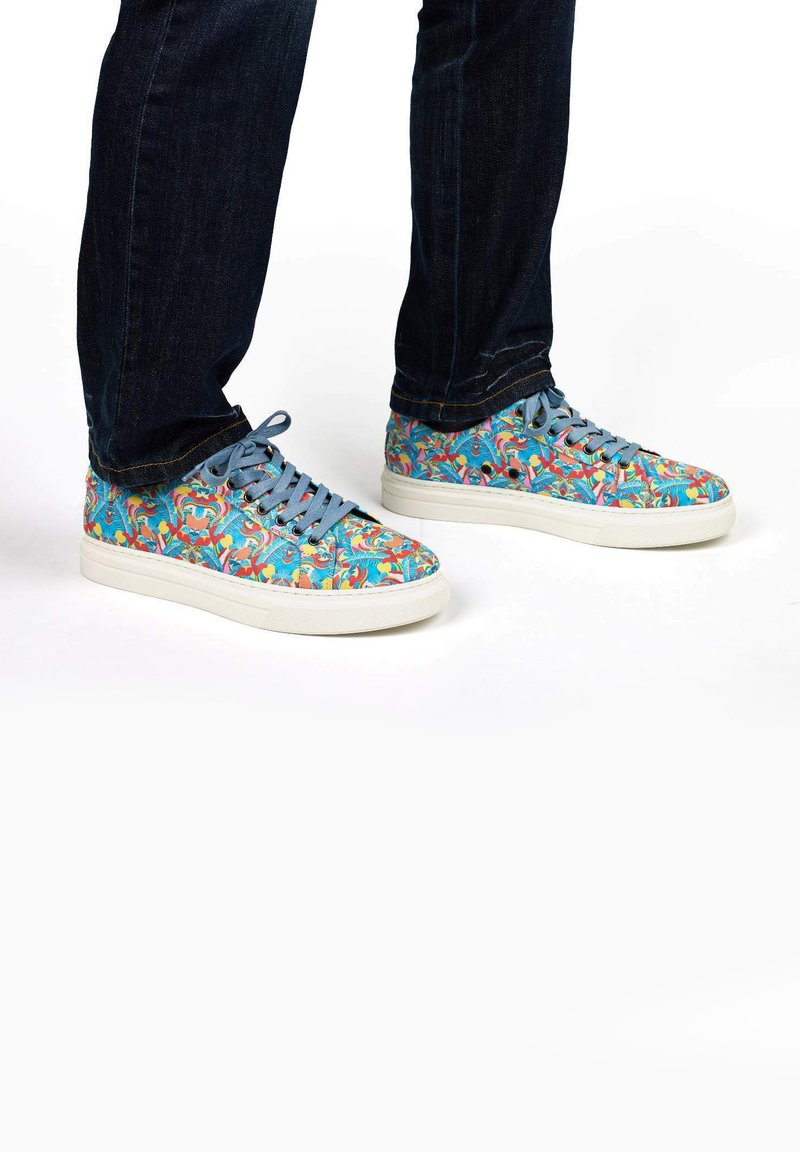 Canvas sneakers with a blue background featuring a colorful pattern of tropical birds, white sole, and light blue laces.