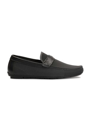 Black slip-on shoes featuring a textured mesh upper, leather accents, and a smooth toe design. Flexible rubber sole with subtle stitching.