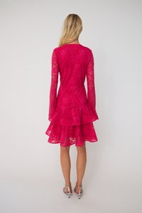 Rochie din dantelă fucsia cu mâneci lungi și tiv evazat, având un design în straturi și model floral, asortată cu sandale argintii cu toc.