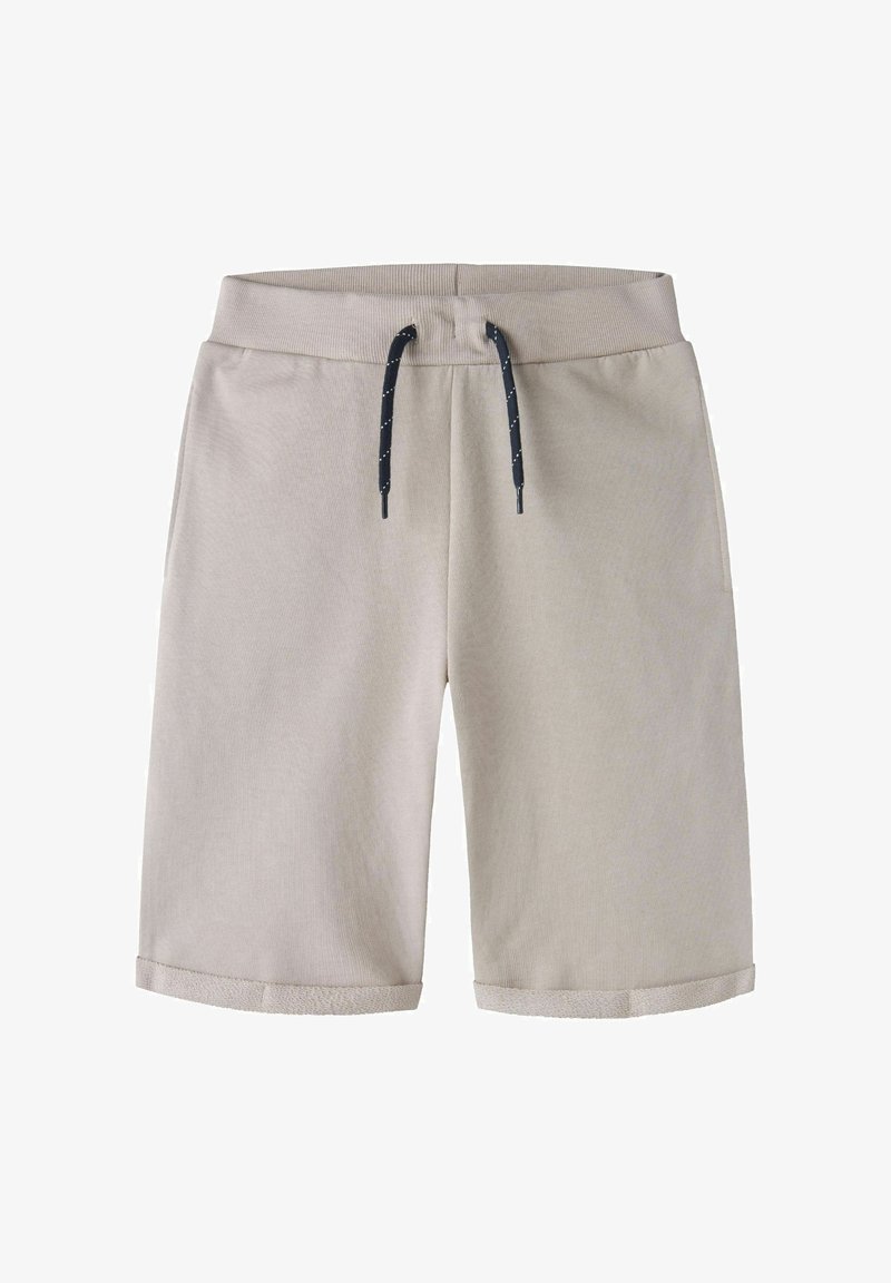 Shorts en coton beige clair avec ceinture élastique et cordon noir, avec ourlets retroussés.
