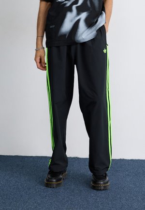 DRILL - Tracksuit bottoms - black/signal green