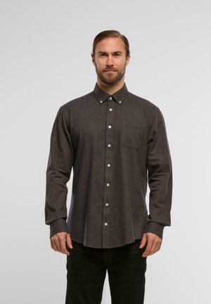 Dark gray long-sleeve button-up shirt with a collar, white buttons, and a single chest pocket, made from a textured fabric.