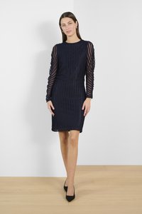 Navy blue dress with long sleeves, textured pattern, and fitted silhouette. Smooth fabric, knee-length, and a round neckline.