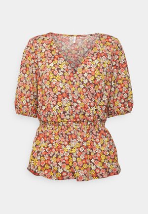Blomstret bluse med en brun baggrund. Har farverige blomstermønstre i gul, pink og hvid. V-hals design og elastisk talje.