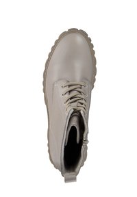 Beiger Leder-Stiefelette mit rundem Zehenbereich, Schnürung vorne und seitlichem Reißverschluss. Dicke Gummisohle mit strukturiertem Profil. Weiches Innenfutter.