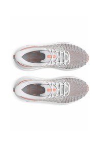 Athletic shoes with a white mesh upper, orange accents, and reflective detailing. Features a rounded toe and lace-up design.