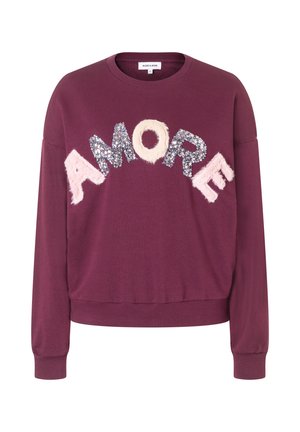 Dark purple long-sleeve sweatshirt with "A MORE" text in mixed fuzzy and sequined letters across the chest, ribbed cuffs and hem.