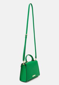Green leather handbag with a structured design, featuring a top handle, adjustable strap, and gold-tone hardware accents.