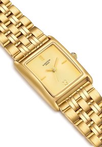 Kuldtooniline ristkülikukujuline randmevaatamisega, millel on tekstureeritud kollane kellaplaat, minimalistlikud tähised ja kudunud metallists. Klassikaline disain poleeritud detailidega.