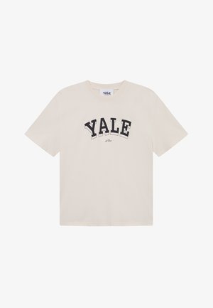 Krem majica od pamuka, kratki rukavi, okrugli izrez, s natpisom "YALE" u podebljanim crnim slovima na prednjoj strani. Glatka tekstura, ležeran kroj.