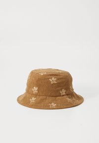 Bruine corduroy emmerhoed met beige bloemenborduurwerk, voorzien van een brede, zachte rand en een gestructureerde kroon.