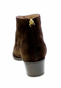 Bottine en daim marron avec un bout rond, un talon lisse et un détail de fermeture éclair dorée à l'arrière. Surface texturée et silhouette classique.