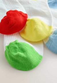 Colorful ankle socks in white, featuring red, yellow, green, and blue ribbed cuffs. Soft, knitted texture with a round toe design.