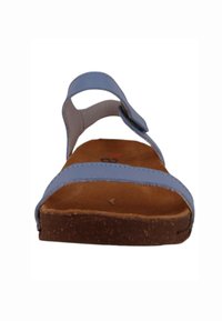 Blue strappy sandal with a brown cork sole. Adjustable upper straps, contoured footbed, and flat design for comfort and support.