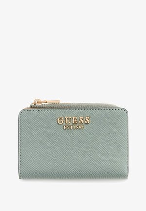 Green textured wallet with gold logo "GUESS EST 1981" on the front, featuring a zip closure and rectangular shape.