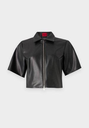 Black faux leather cropped jacket with short sleeves, collar, and front zipper. Features a logo tag in red. Smooth texture.