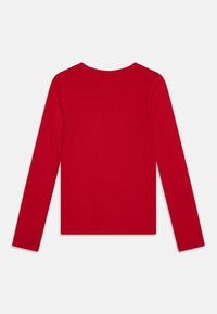 Red long-sleeve top featuring a round neck, made of smooth cotton material, with a solid color and no visible patterns or embellishments.