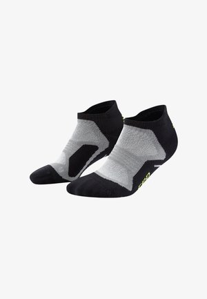Calzini alla caviglia neri e grigi con un design testurizzato, che presenta un motivo geometrico e un piccolo logo giallo sul tallone.