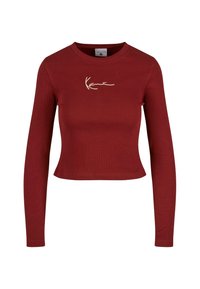Long-sleeve cropped top in burgundy ribbed fabric with a round neckline and a signature logo embroidered in white on the chest.