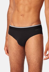 Zwarte katoen boxershorts met een grijze elastische tailleband, met een klassiek ontwerp en een soepele textuur. Geen patronen of versieringen zichtbaar.