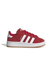Sneaker rosse in suede con design a tre strisce bianche, colletto imbottito e suola in gomma. Presenta un'accensione texture sul tallone.