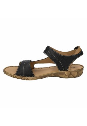 Schwarze Leder-Sandalette mit zwei breiten Riemen, Ausschnitten und einer strukturierten braunen Gummisohle mit floralen Mustern. Mit genähten Details versehen.