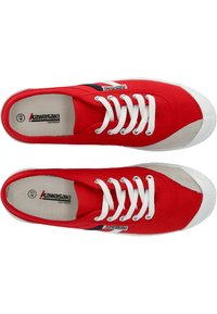 Baskets en toile rouges avec des lacets blancs, dotées d'un bout gris et d'une bande d'accent bleu marine. Étiquette de marque située sur le côté.