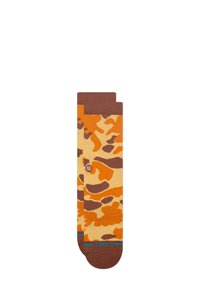 Chaussettes à motifs camouflage marron, orange et crème avec une texture lisse, ornées d'une ligne d'accent bleu et d'un détail logo.