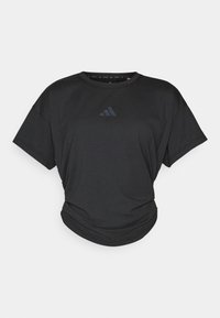 T-shirt atletica nera con maniche corte, scollatura rotonda e orlo leggermente arricciato. Presenta un sottile logo scuro sul petto.