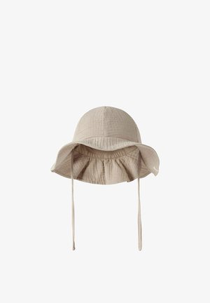 Beige soft fabric bucket hat with wide, floppy brim and adjustable chin straps, designed for sun protection.