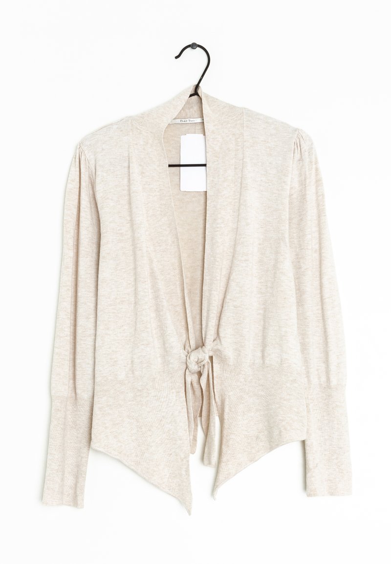 Cardigan beige clair à manches longues avec un nœud noué devant, poignets côtelés, épaules légèrement bouffantes, suspendu à un cintre noir sur fond blanc.