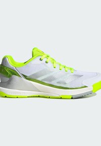 White athletic shoe with neon green accents, mesh upper, textured sole, and reflective detailing. Features a cushioned midsole.