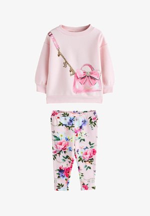 Toddler outfit with light pink sweatshirt featuring a printed pink handbag with bow, paired with pink floral patterned leggings.
