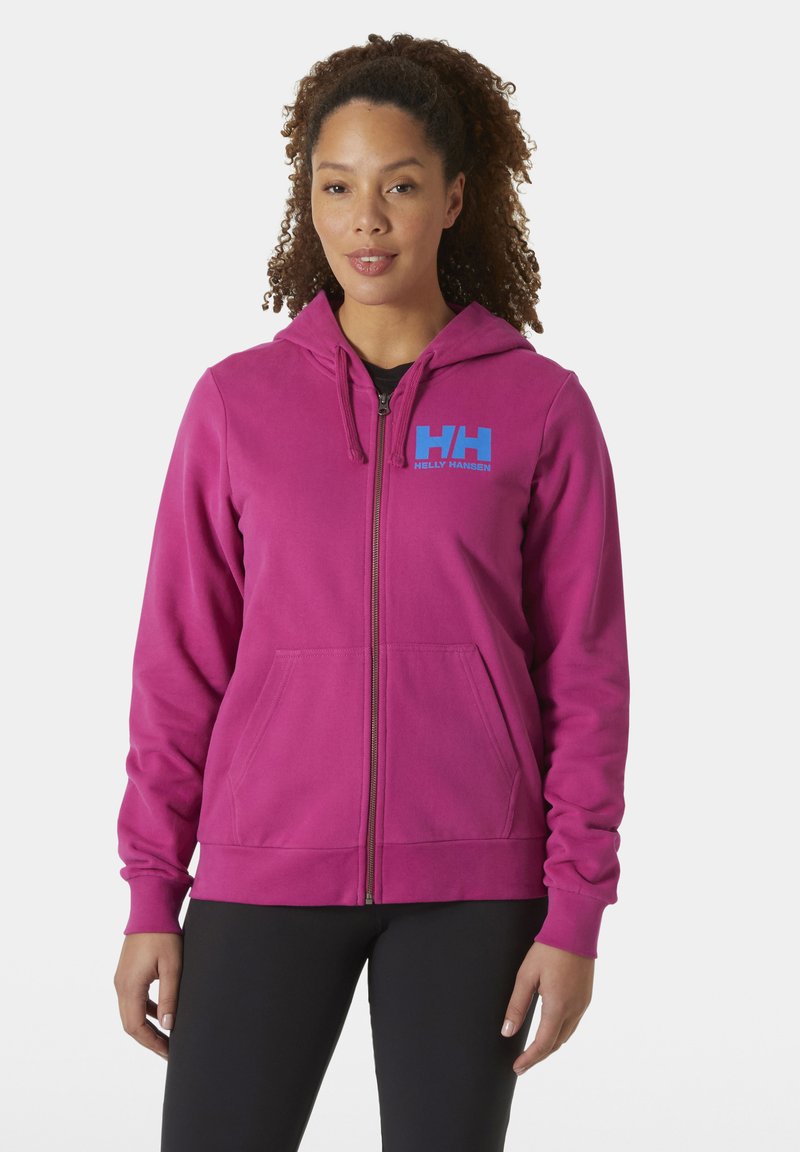 Sudadera con cremallera fucsia, con bolsillos frontales y un logo "HH" azul. Tejido suave, corte relajado y capucha con cordón.