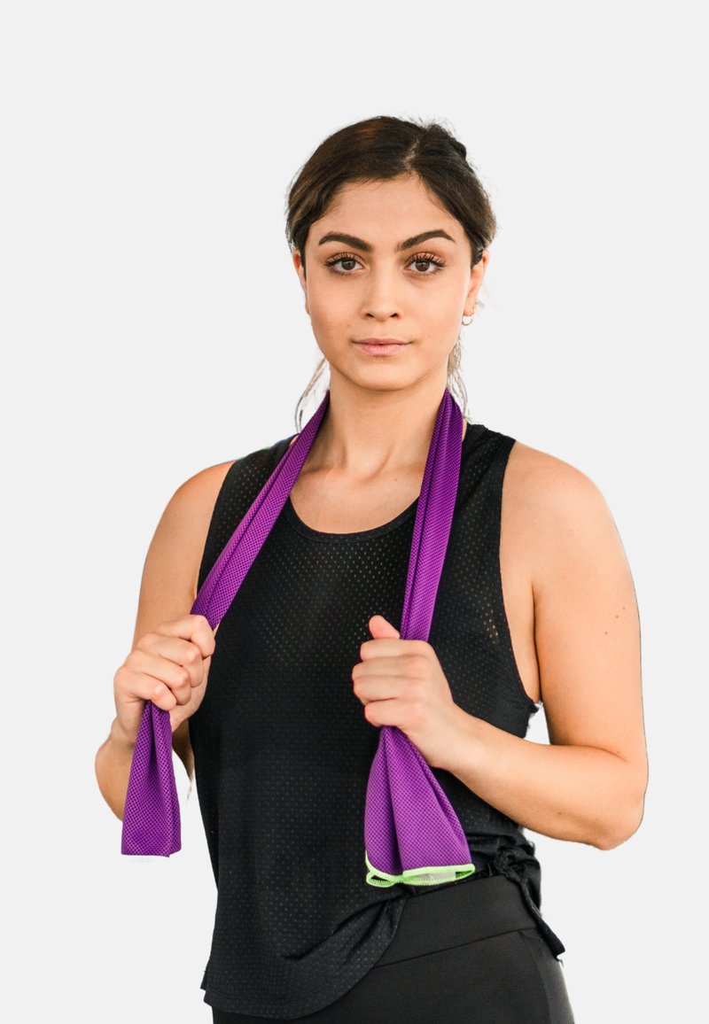 Purple resistance bands with green accents held by a person wearing a black, sleeveless, textured athletic top. Plain background.