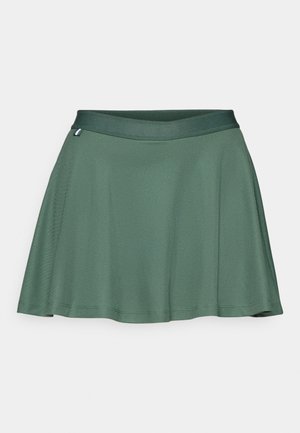 Green skater skirt made of smooth fabric, featuring a wide waistband and a flared design that creates a loose fit and subtle movement.