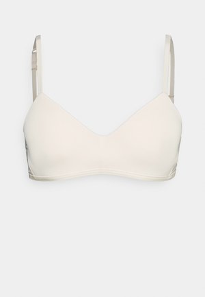 Lys beige bh med et glatt, strømlinjeformet design. Har trekantede kopper og tynne, justerbare stropper. Laget av mykt, elastisk materiale.