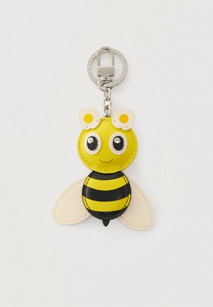 Yellow and black leather bee keychain with stitched details, large eyes, flower accents on top, and metal clip for attachment.