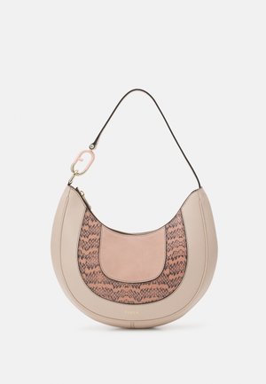 Half-moon shaped beige handbag with brown and black snake print accents, a black strap, and a pink clip attached to the strap.