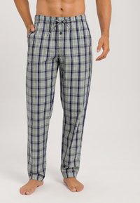 Geruite pyjamabroek met een groen, marineblauwe en witte kleurenschema. Gemaakt van zachte stof met een elastische tailleband en een trekkoord.