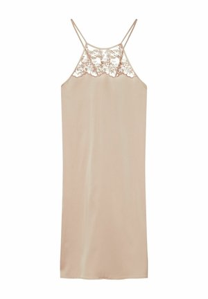 Beżowa sukienka na ramiączkach z cienkimi podwójnymi paskami i kwiatową koronką na wysokości biustu na jednolitym białym tle.