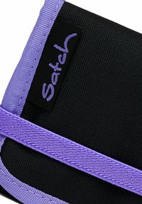 Black fabric wallet featuring a purple strap and stitching. Includes a black tag with "Satchel" embroidered in purple.