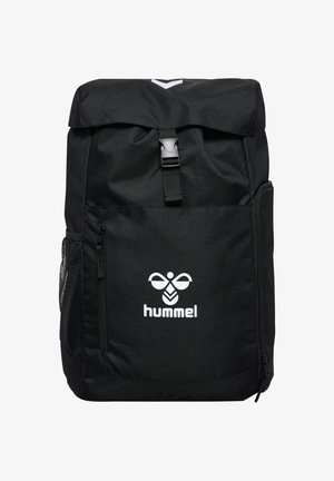 Mochila negra Hummel con bolsillo frontal con cremallera, bolsillo lateral de malla, solapa superior asegurada con hebilla y logo blanco en el frente.